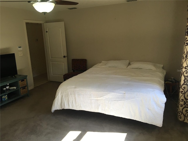 bedroom with ceiling fan and dark carpet