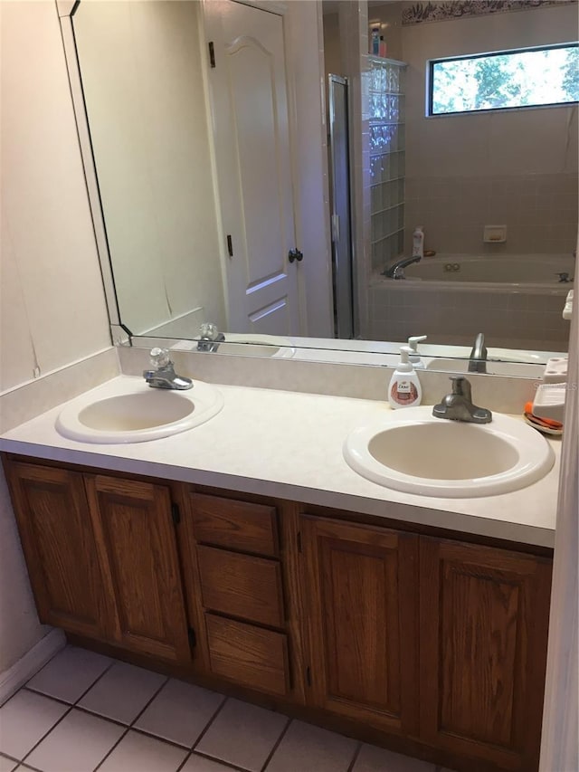 bathroom with tile patterned flooring, vanity, and plus walk in shower