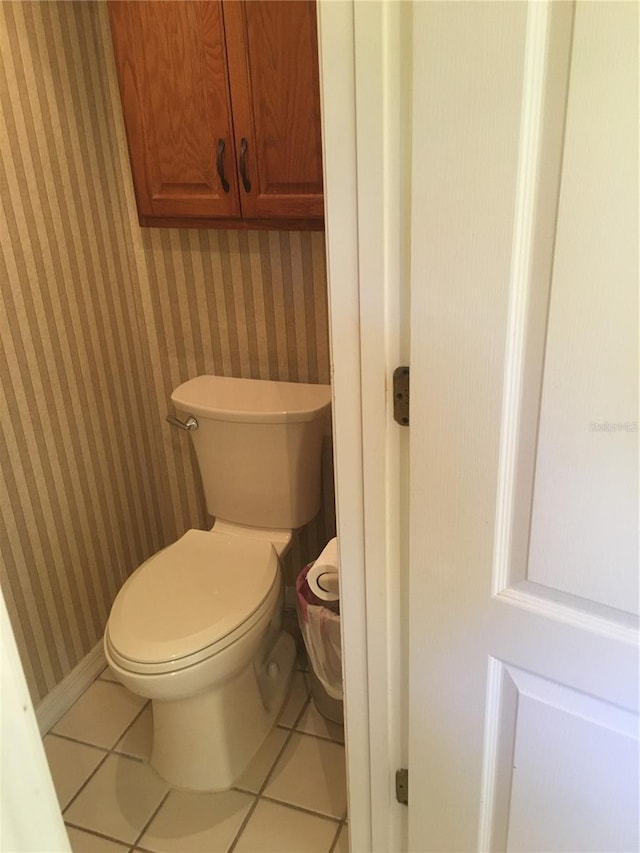 bathroom with tile patterned flooring and toilet