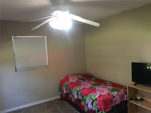 bedroom with ceiling fan and dark carpet