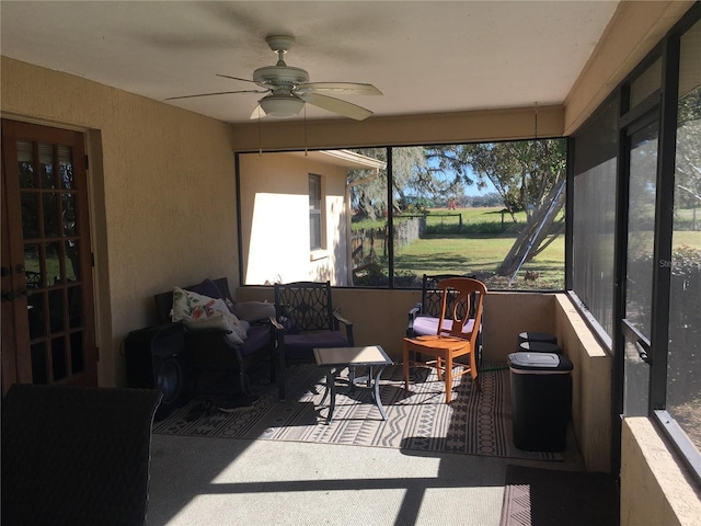 sunroom featuring ceiling fan