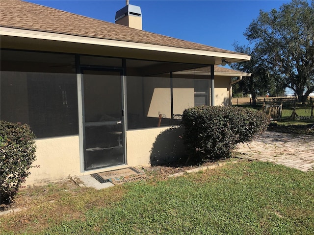 back of property featuring a lawn