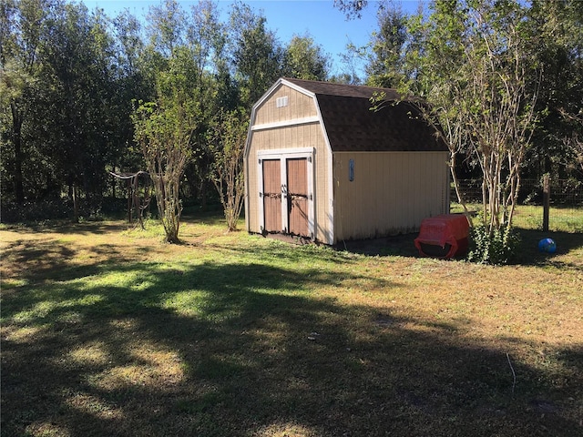 view of outbuilding featuring a lawn