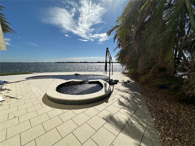 view of patio with a water view