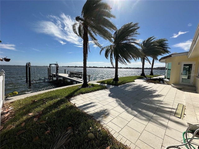 view of patio / terrace featuring a water view and a boat dock