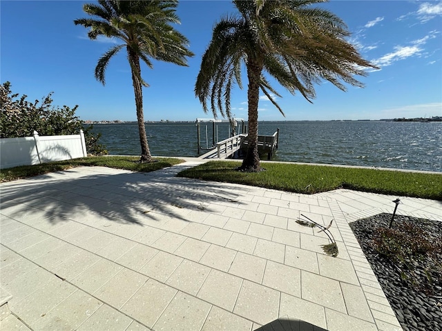 view of patio / terrace with a water view and a boat dock