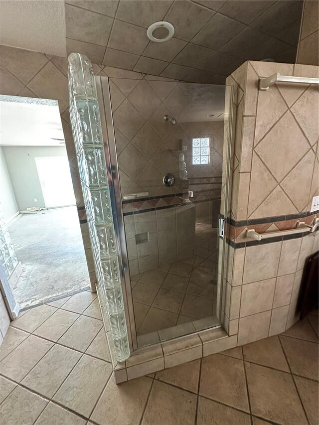 bathroom featuring tile patterned flooring and a shower with door