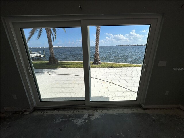 doorway to outside featuring concrete flooring and a water view