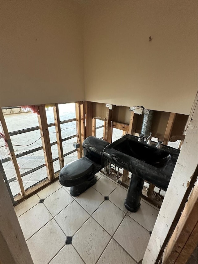 bathroom featuring tile patterned floors and a high ceiling