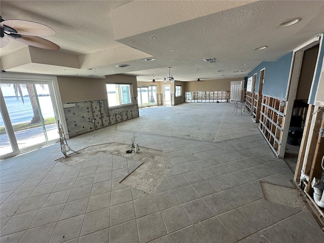 spare room featuring visible vents, a textured ceiling, and ceiling fan