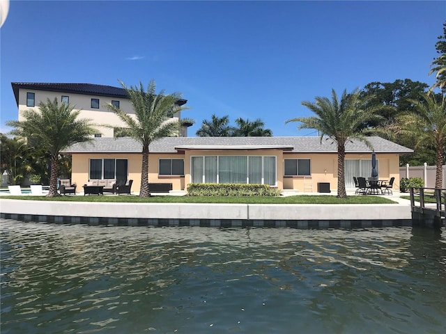 rear view of property with stucco siding and a patio