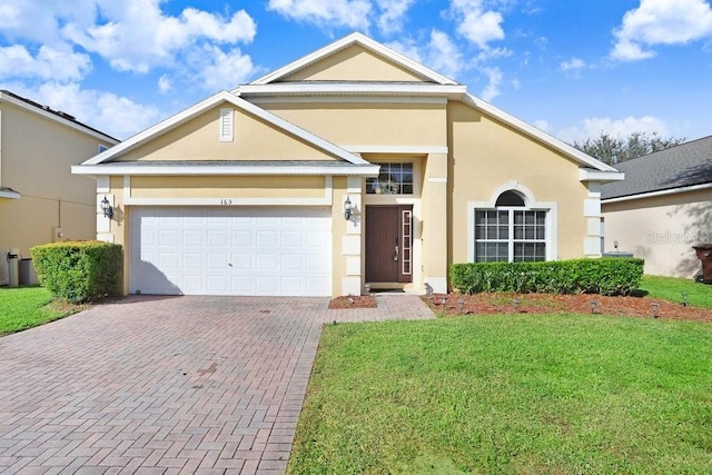 view of front facade with a front yard and a garage