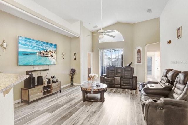 living room featuring high vaulted ceiling, light wood-type flooring, and ceiling fan