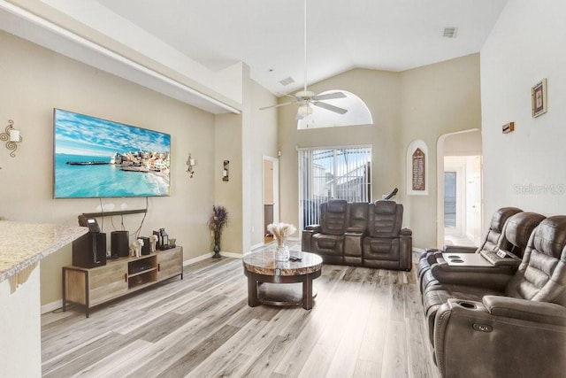 163 Andalusia Loop, Davenport, FL 33837 - living area with light wood-type flooring, a ceiling fan, high vaulted ceiling, arched walkways, and baseboards