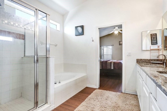 163 Andalusia Loop, Davenport, FL 33837 - full bath featuring connected bathroom, a stall shower, wood finished floors, a garden tub, and double vanity