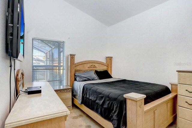 bedroom featuring light colored carpet