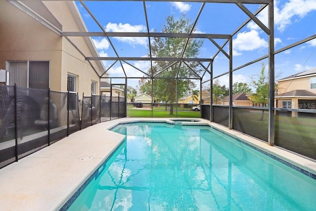 view of swimming pool featuring a patio area, a lawn, and glass enclosure