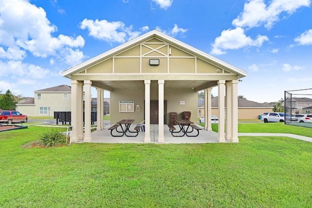 163 Andalusia Loop, Davenport, FL 33837 - rear view of property featuring a yard, stucco siding, and a patio area
