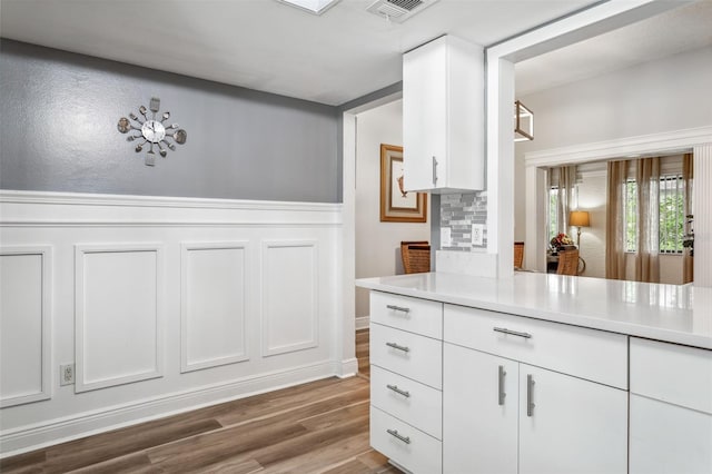 kitchen featuring white cabinetry and hardwood / wood-style flooring