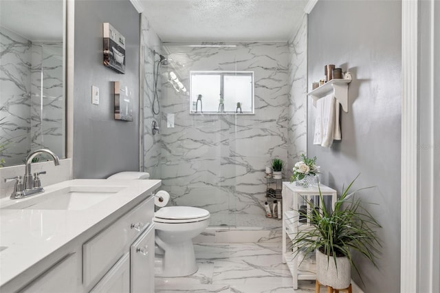 bathroom featuring vanity, toilet, a textured ceiling, and an enclosed shower