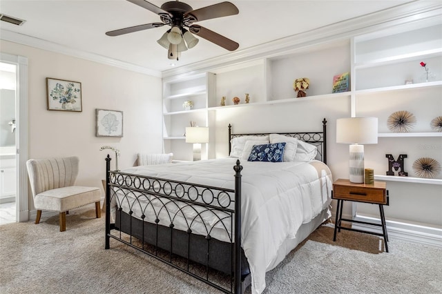 bedroom with crown molding, connected bathroom, carpet, and ceiling fan