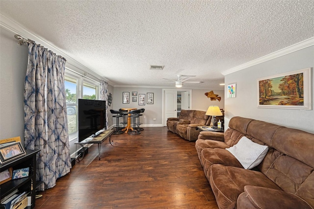 living room featuring a textured ceiling, crown molding, ceiling fan, and dark wood-type flooring