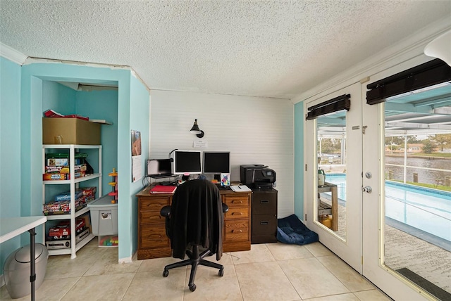 home office with light tile patterned flooring and a textured ceiling