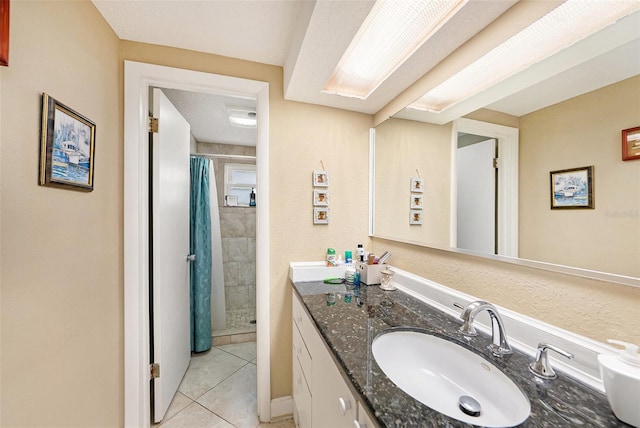 bathroom with tile patterned floors, vanity, and walk in shower