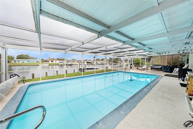 view of swimming pool with a water view and a patio