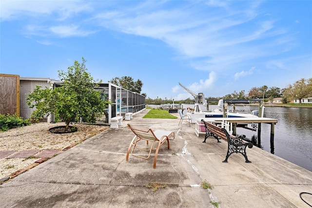 view of patio / terrace featuring glass enclosure, a water view, and a boat dock