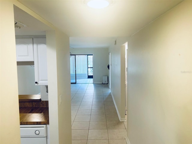 hall with light tile patterned floors