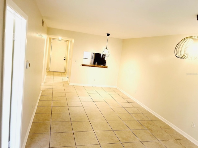 unfurnished dining area featuring light tile patterned floors