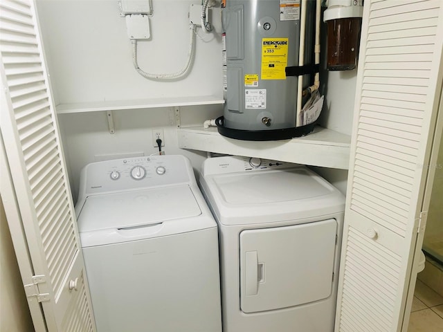 washroom with electric water heater, washer and clothes dryer, and tile patterned floors