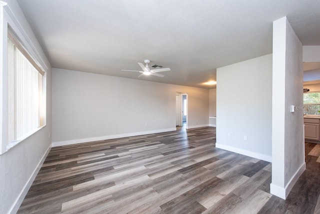 spare room featuring dark wood-type flooring and ceiling fan