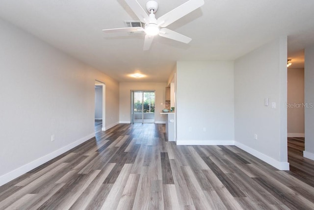 spare room with dark wood-type flooring and ceiling fan