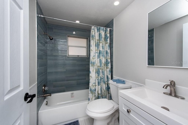 full bathroom featuring toilet, vanity, and shower / bathtub combination with curtain