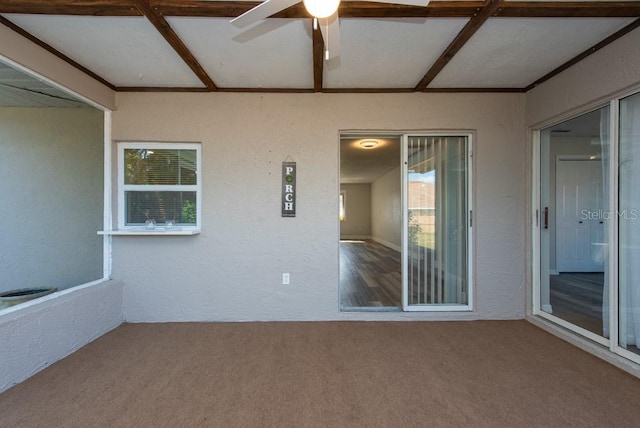 unfurnished sunroom with ceiling fan