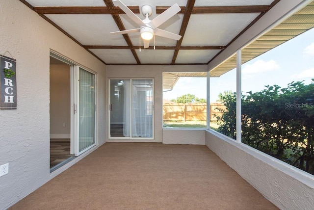 unfurnished sunroom featuring ceiling fan