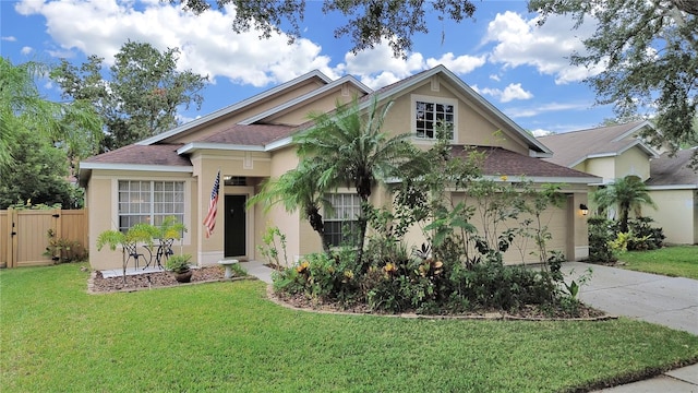 view of front of house featuring a garage and a front lawn