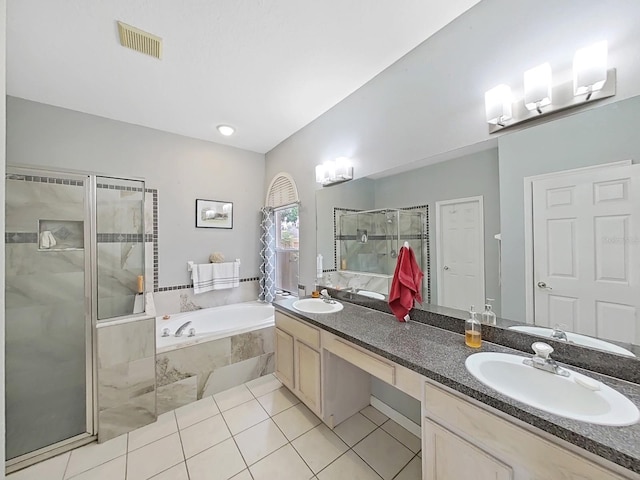 bathroom featuring independent shower and bath, vanity, and tile patterned flooring