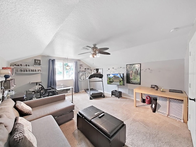 living room with lofted ceiling, a textured ceiling, carpet flooring, and ceiling fan