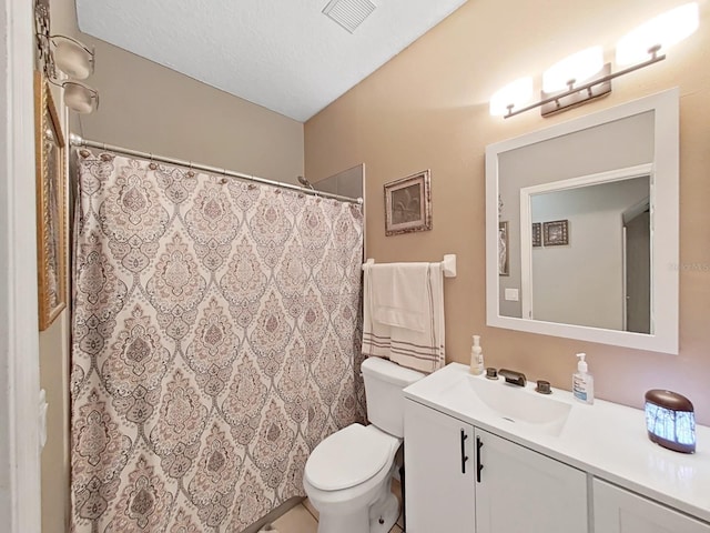 bathroom with toilet, vanity, a textured ceiling, and a shower with shower curtain