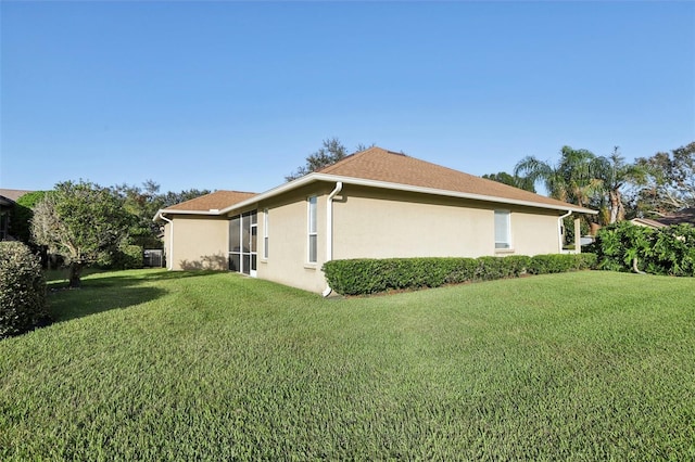 view of side of property with a yard