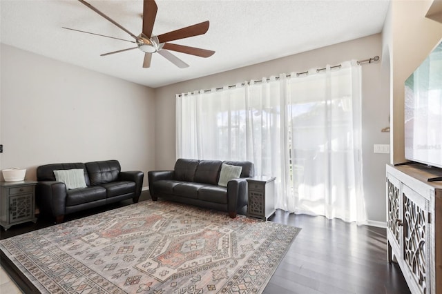 living room featuring ceiling fan and wood-type flooring