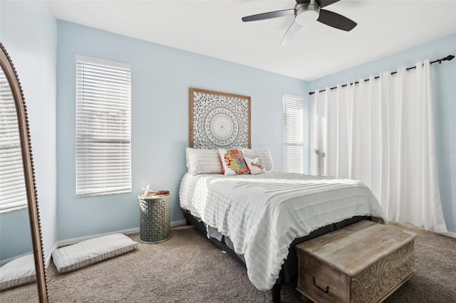 carpeted bedroom with ceiling fan and multiple windows