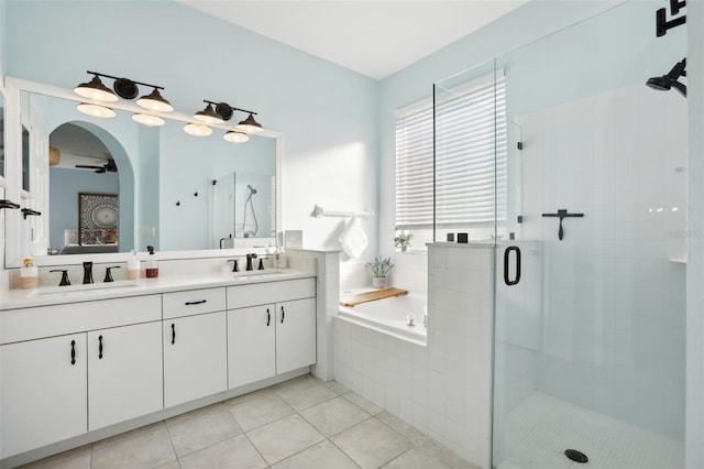 bathroom with tile patterned floors, vanity, ceiling fan, and plus walk in shower