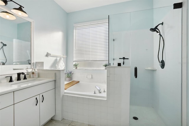 bathroom featuring plus walk in shower, tile patterned flooring, and vanity