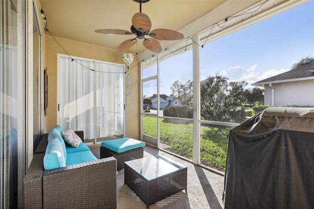 sunroom featuring ceiling fan