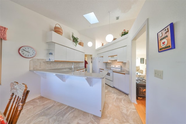 kitchen with kitchen peninsula, white cabinets, hanging light fixtures, and white appliances