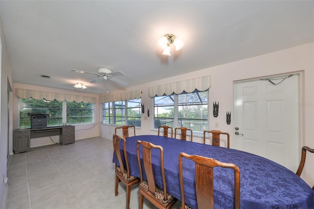 tiled dining space featuring ceiling fan